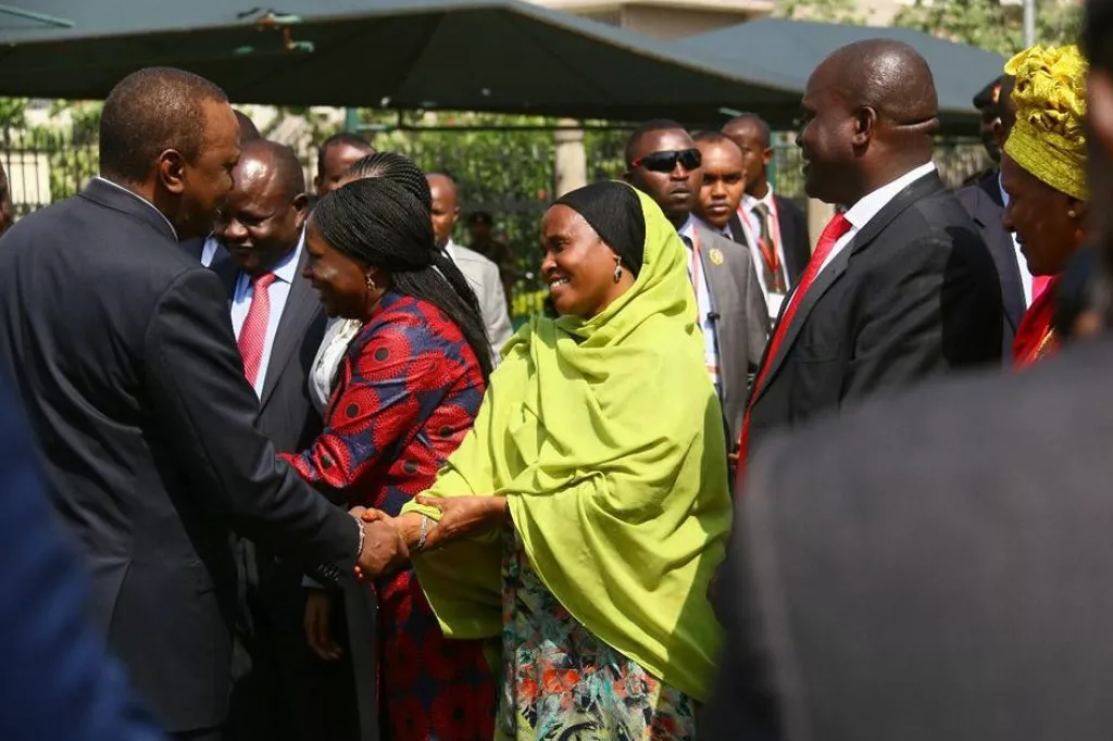 Fatuma Dullo, greets President Uhuru Kenyatta.