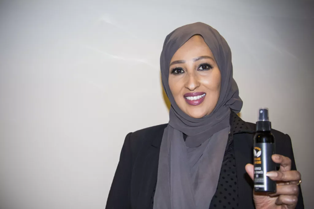 Muna Magan holding her new product.