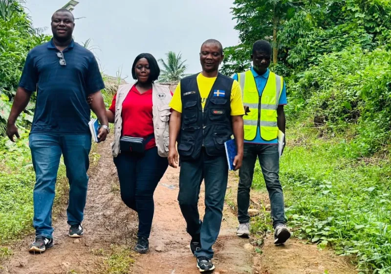 People walking down a dirt road.